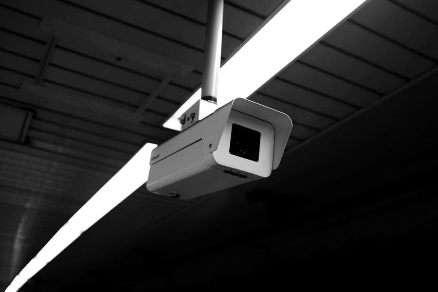 CCTV camera mounted beneath a ceiling structure